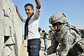 Image 20U.S. Army soldier searches an Iraqi boy, March 2011. (from History of Iraq)