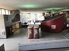 "Forum" meeting space, with main entrance at rear and cafeteria at left, viewed from mezzanine staff lounge