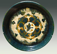 A ceramic offering plate with "three colours" glaze, decorated with a bird and trees, 8th century