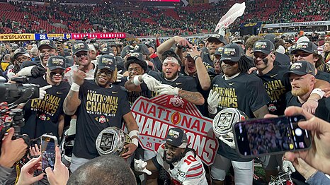 Multiple players pose for a celebratory group photo.