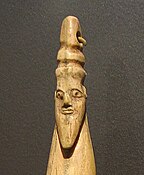 Hippopotamus tusk with carved head of a bearded man with torus-like headgear, Late Naqada I – Early Naqada II, 3800–3400 BC. Brooklyn Museum.[11]