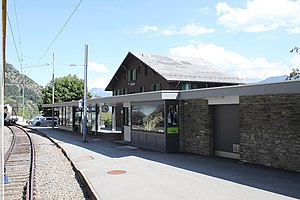 Canopied platform with three-story building behind it