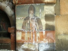 Frescos of clergymen under the portico at the front of the church.