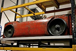 red mail car with large wheels and an open top where the mailsacks are placed