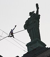 Didier Pasquette walking a tightrope between the twin statues atop the Liberty Building in downtown Buffalo, New York, 2010