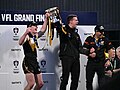 Werribee captains Dom Brew (L) and Nick Coughlan (R) raise the premiership cup with coach Jimmy Allan