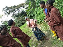 Four people speaking with a farmer in Nigeria