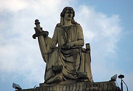 Sculpture of Justice with her scales and sword on the top of the building.