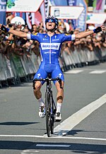 Remco Evenepoel crossing the finish line to win the race