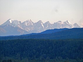 Seven mountains lined up neatly in a row in the far distance