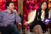 Ken Jeong and Awkwafina hold purple MTV cards