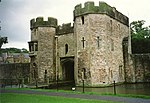 Gatehouse and boundary wall with bridge over moat