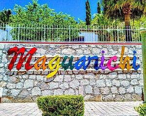 Colour photograph of Maguarichi sign, every letter is a different colour to the last