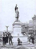 Workers finish installing Gelert's statue of a Chicago policeman in Haymarket Square, 1889. The statue now stands at the Chicago Police Headquarters.