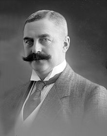 Black and white photo of the headshot of a middle aged man