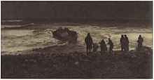 Dark photograph showing a group of people on the coast, looking out to a sinking boat