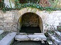 Fountain in Tourtoirac (Dordogne), probably dating to Roman times or earlier. The inhabitants have built a wall around a spring.