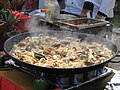 A variety of seafood to which rice will be added to make paella in Mexico