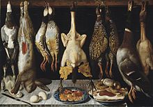 A knife, two eggs, and two platefuls of food sit atop a table. A collection of wild game hangs over the table: eight birds and a hare.