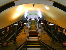 Escalators with bronze uplighters at Southgate Station