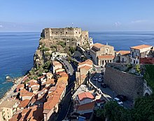 Photograph of a stone castle built on a rock promontory on the coast