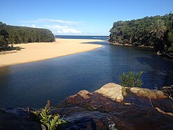 Wattamolla lagoon, looking towards the Tasman Sea, with Wattamolla Beach in the distance and the waterfall in the foreground