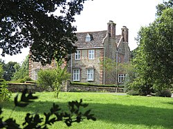 Stone house with trees in the foreground