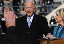 Photo of Biden raising his right hand, with his left hand placed on a thick Bible