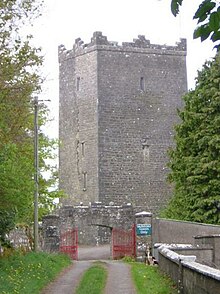 A square grey brick building.