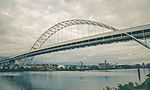 Pale green metal arched bridge