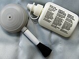 A simple photographic lens cleaning kit, consisting of a detergent, microfiber cloth, and an anti-dust airbrush.