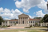 A Neoclassical building beneath a bright blue sky