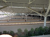 Looking across the extensive platforms of Shenzhen North railway station. The train in clear view is a longer 16 car train, 8 car high speed trains are hidden under the main station building.