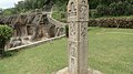 The inscribed Kiratarjuna pillar, now near lower cave, restored from the Durga temple hill above.