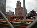 From the south, a view of ongoing excavation in July 2002. The slurry wall circumscribing the site is visible, as is the damaged Verizon Building in the background.