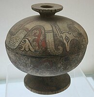 A painted pottery dou vessel with a dragon design from the Warring States period (403–221 BC)