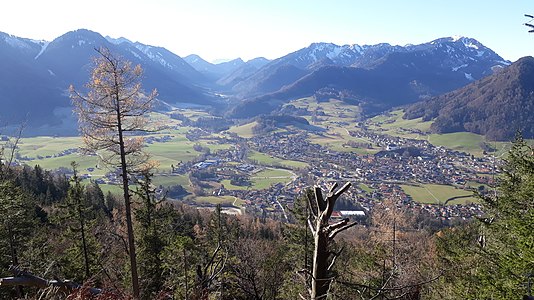 Gipfelblick nach Südwest ins Brander Tal. Im Vordergrund der Ruhpoldinger Talkessel mit Unternbergmassiv (links) und Hochfellnmassiv (rechts). Im Hintergrund ist der Zahme Kaiser zu erkennen und auch der Hochgern (1748 m) ragt gerade noch hervor.