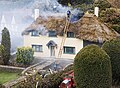 Model of a burning house at Bekonscot, Beaconsfield, UK