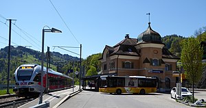 Two-story building with arched roof and turret