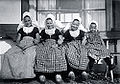 Girls in the traditional costume of Arnemuiden, featuring caps with large "wings"