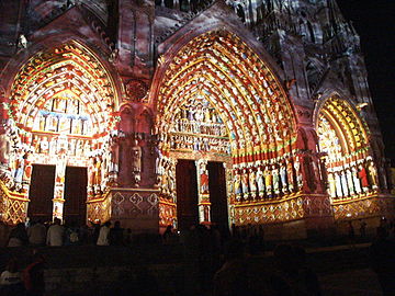 Portals of Amiens Cathedral with coloured light showing the original appearance