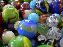 multiple toy marbles of various sizes, colors, and designs