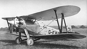 black and white photograph of a Bristol Type 101 aeroplane on the ground in a field. it looks to be about to take off with the propeller spinning.