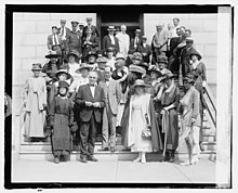 A 1920 photo of women and men of the National Women's party trying to convince Senator Harding to provide them with the 36th state.