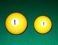 Comparison of 68 mm (211⁄16 in) Russian and 57 mm (21⁄4 in) American-style billiard balls for pool.