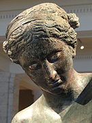 Closeup of Apollo's head and the arrangement of his hair.
