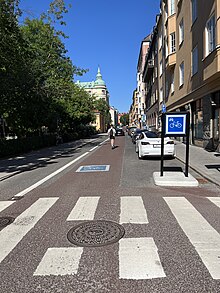 Cykelgata in Stockholm showing a cycle street sign and road markings.