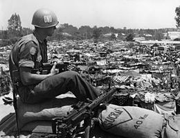 Black-and-white photo of a soldier sitting outdoors