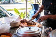 A taquero preparing birria meat in Mexico