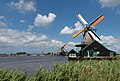Zaanse Schans, windmill (verfmolen De Kat) and in three mills in the background (houtzaagmolen Het Jonge Schaap, former oliemolen De Os and oliemolen De Bonte Hen)